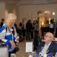 Don Lubbers sitting at his table and chatting with Diane Hoover